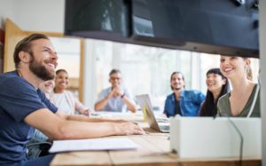 Group of health professionals holding virtual MDT meeting in office