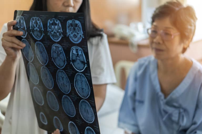 Doctor shows woman patient brain scans